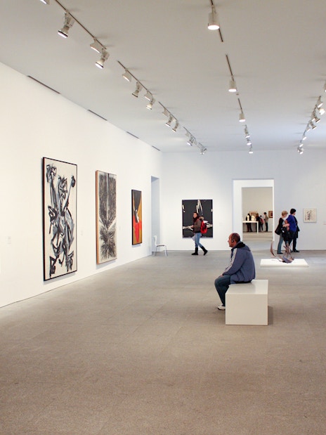 Visitors viewing modern art at Reina Sofia Museum, Madrid.