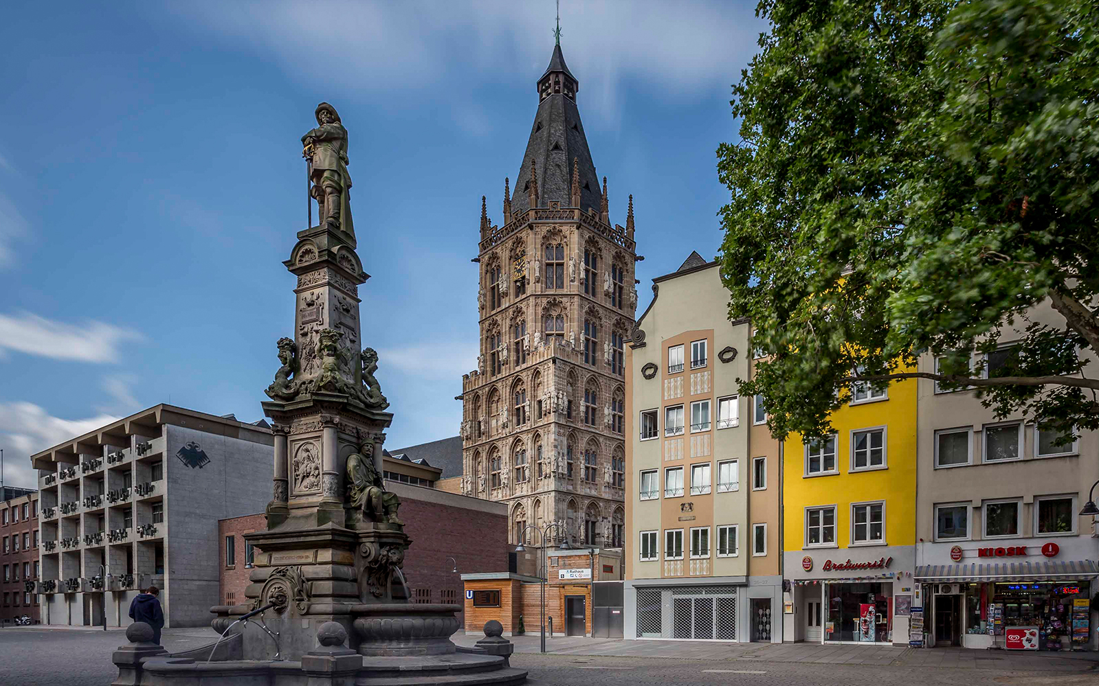 Historic tower and fountain in Cologne city center, Germany.