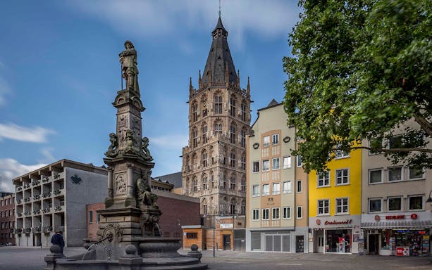 Historic tower and fountain in Cologne city center, Germany.
