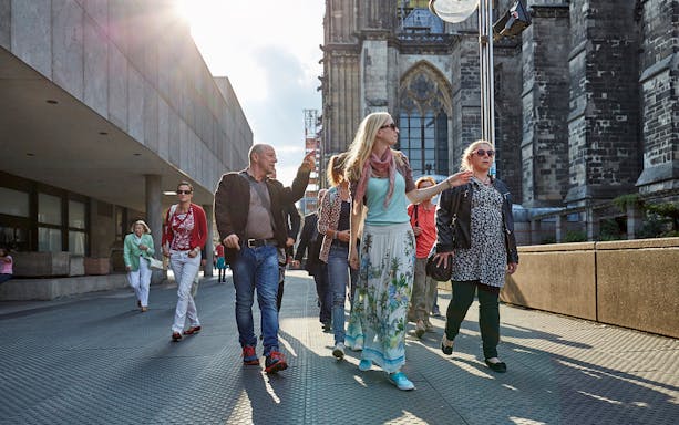Tourists walking near Cologne Cathedral in Germany.