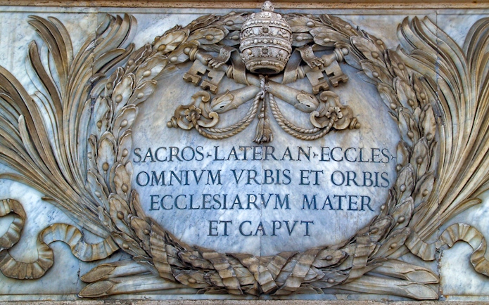 St. John Lateran inscription with papal symbols in Rome, Italy.