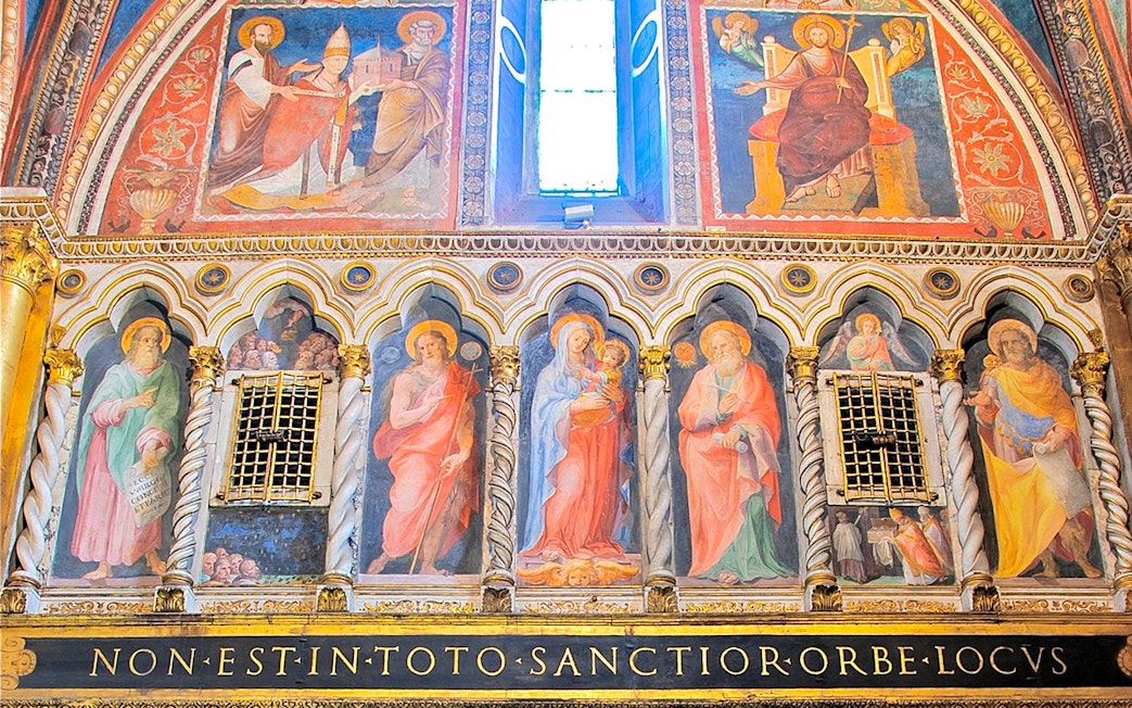 Frescoes inside St. John Lateran Basilica, Rome, depicting religious figures and ornate architecture.