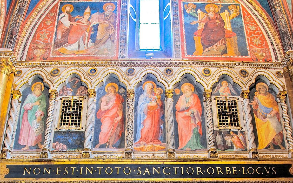 Frescoes inside St. John Lateran Basilica, Rome, depicting religious figures and ornate architecture.