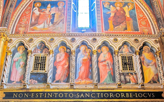 Frescoes inside St. John Lateran Basilica, Rome, depicting religious figures and ornate architecture.