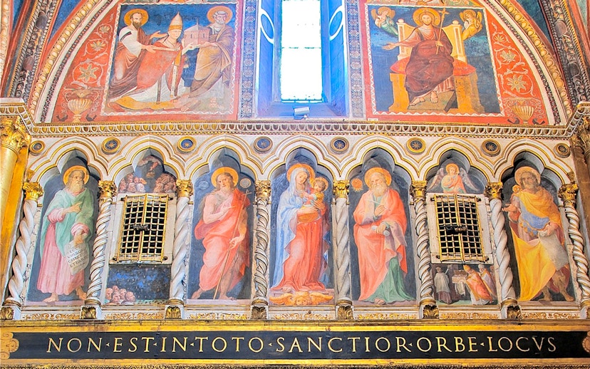 Frescoes inside St. John Lateran Basilica, Rome, depicting religious figures and ornate architecture.