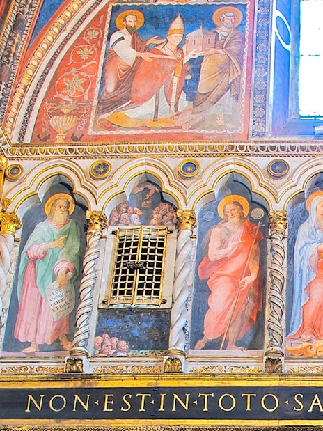 Frescoes inside St. John Lateran Basilica, Rome, depicting religious figures and ornate architecture.