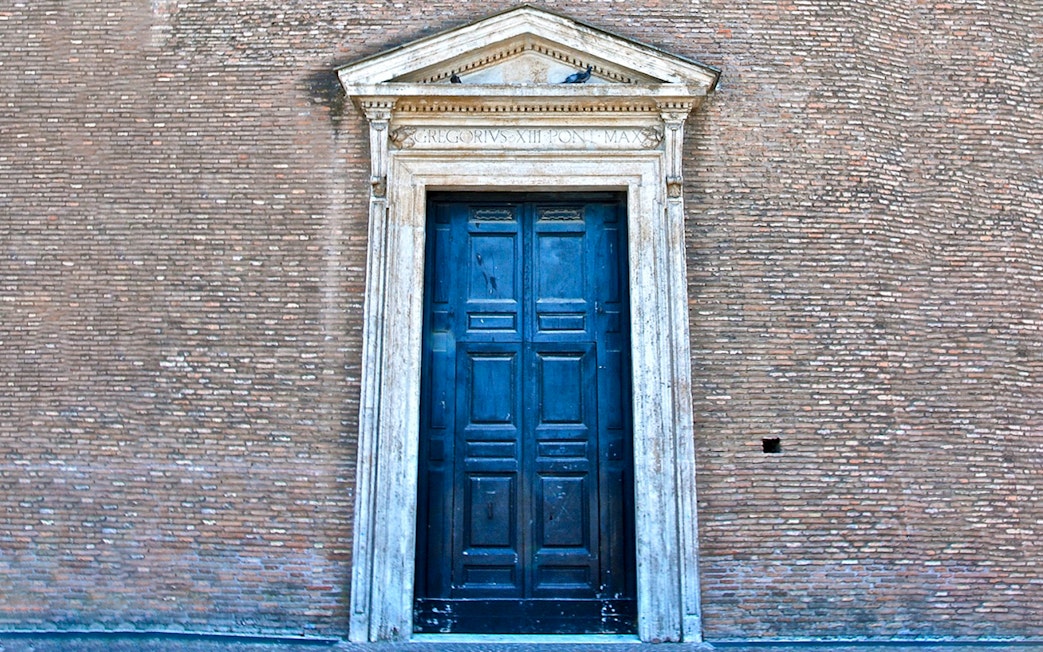 St. John Lateran entrance door in Rome, Italy, with detailed stonework.