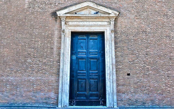 St. John Lateran entrance door in Rome, Italy, with detailed stonework.
