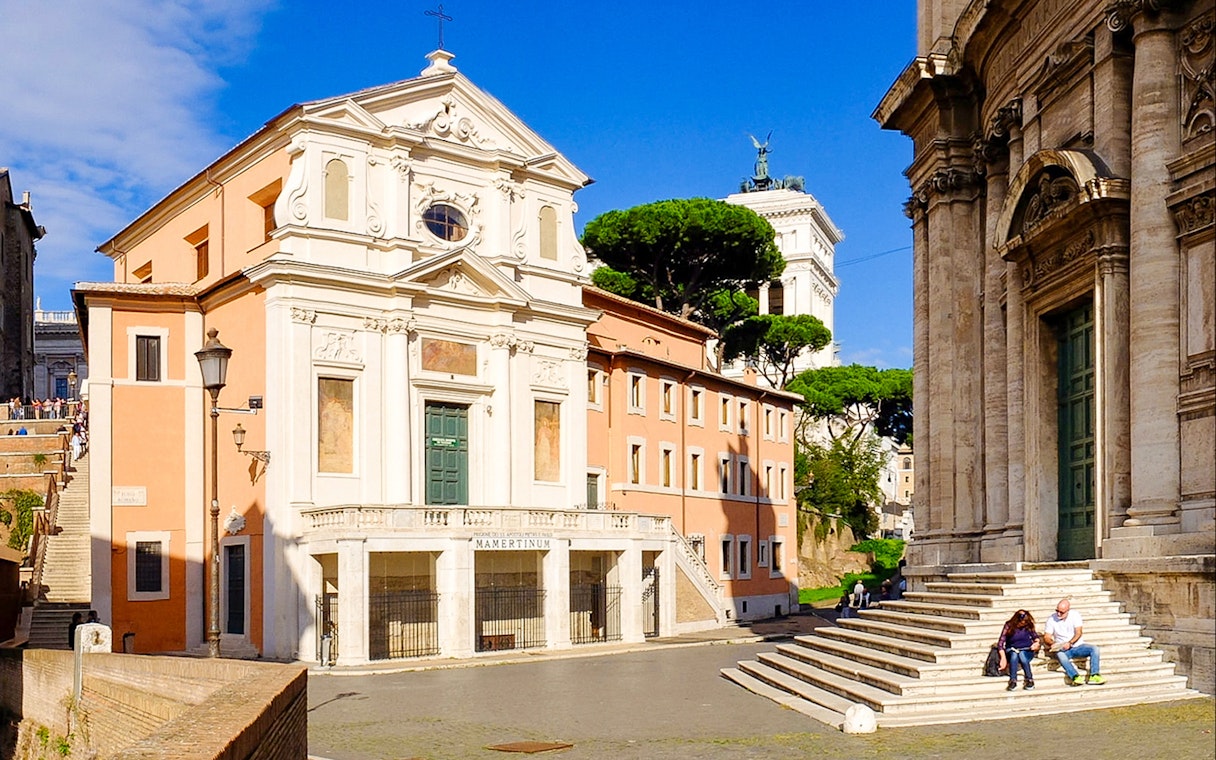 Mamertine Prison entrance with nearby historical buildings in Rome, Italy.