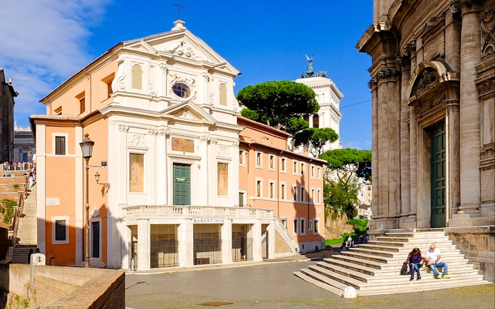 Mamertine Prison entrance with nearby historical buildings in Rome, Italy.