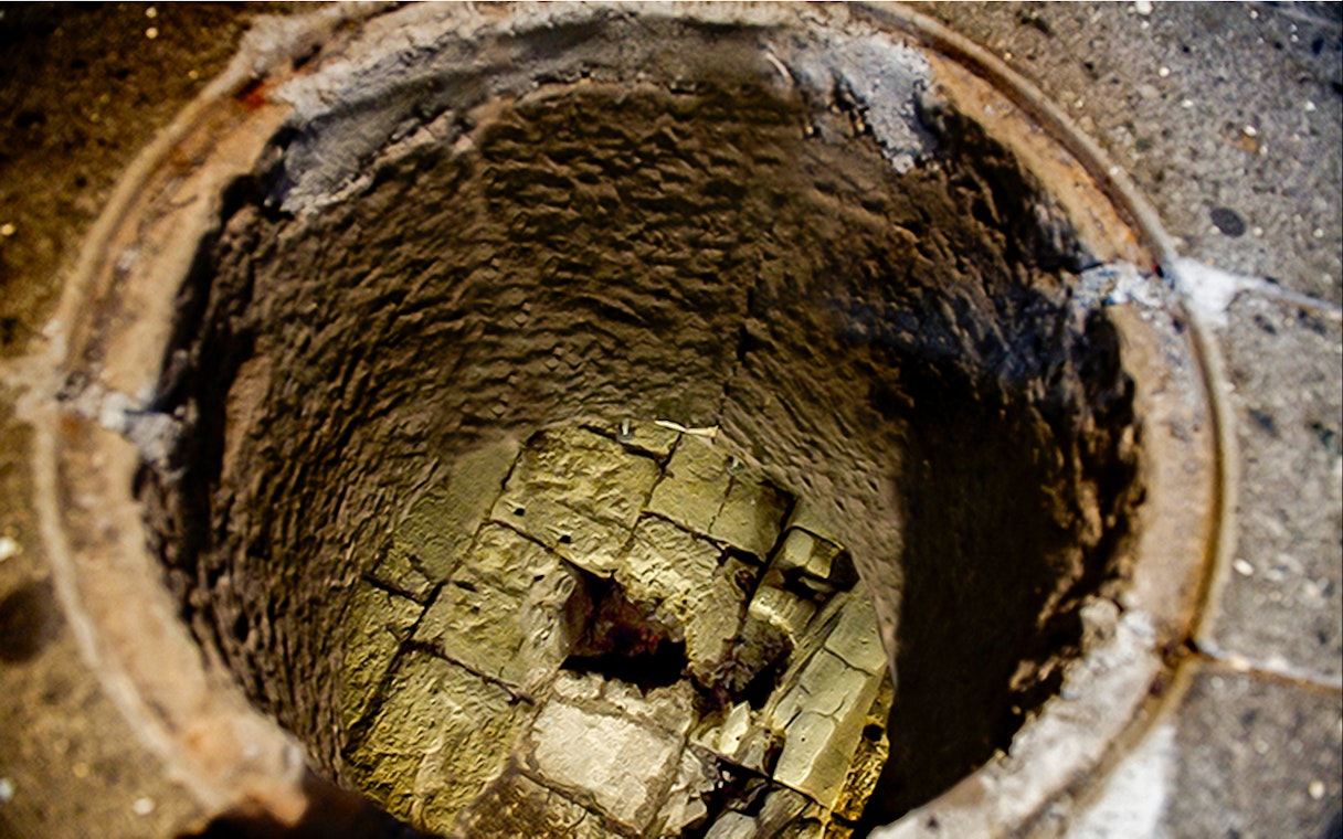 Mamertine Prison ancient stone well entrance in Rome.