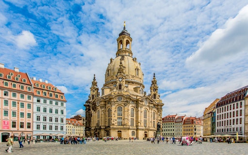 Frauenkirche Dresden with tourists on a guided sightseeing tour in Germany.