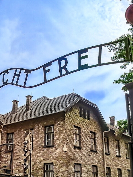 Auschwitz-Birkenau entrance gate with "Arbeit Macht Frei" sign, Poland.