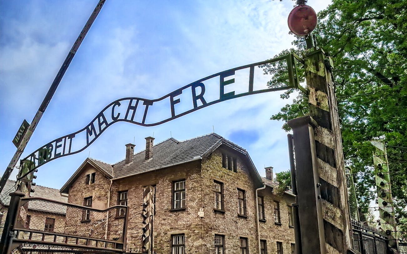 Auschwitz-Birkenau entrance gate with "Arbeit Macht Frei" sign, Poland.