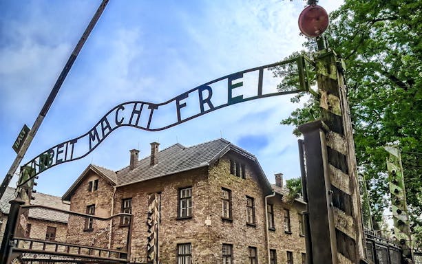 Auschwitz-Birkenau entrance gate with "Arbeit Macht Frei" sign, Poland.