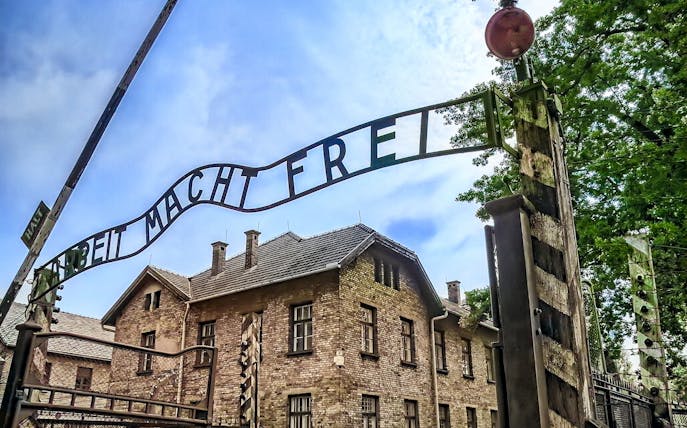 Auschwitz-Birkenau entrance gate with "Arbeit Macht Frei" sign, Poland.