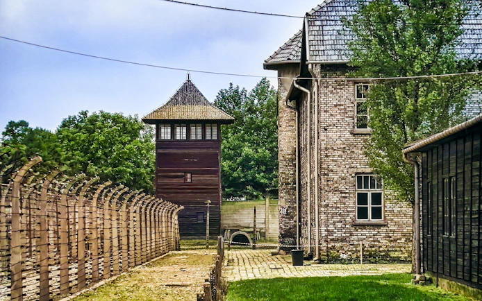 Auschwitz-Birkenau watchtower and barbed wire fence, Poland tour site.