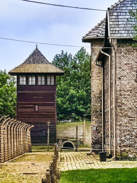Auschwitz-Birkenau watchtower and barbed wire fence, Poland tour site.