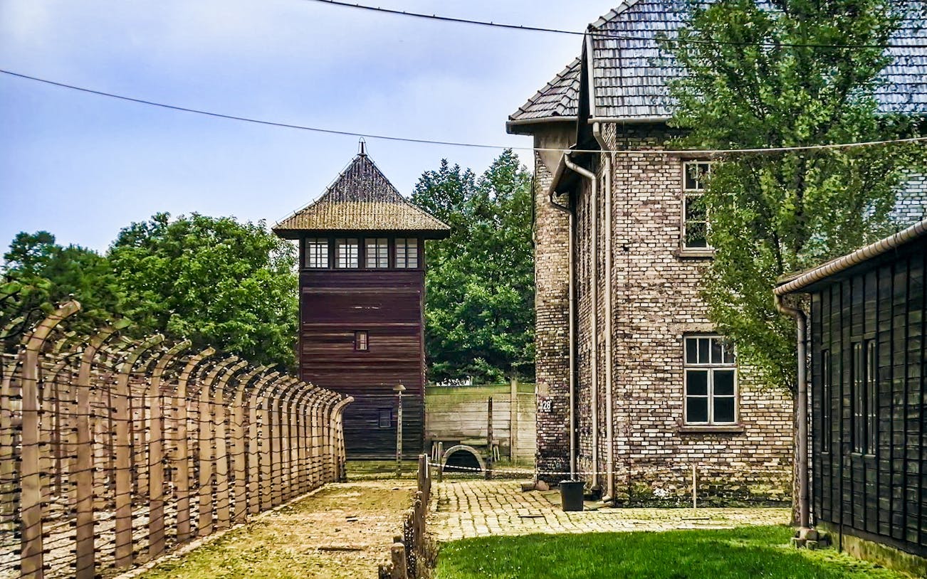 Auschwitz-Birkenau watchtower and barbed wire fence, Poland tour site.