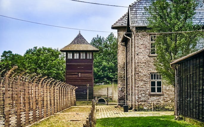 Auschwitz-Birkenau watchtower and barbed wire fence, Poland tour site.