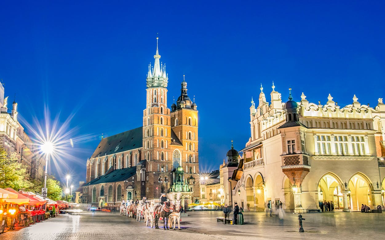 St. Mary's Basilica and Cloth Hall in Krakow's Main Square at night.
