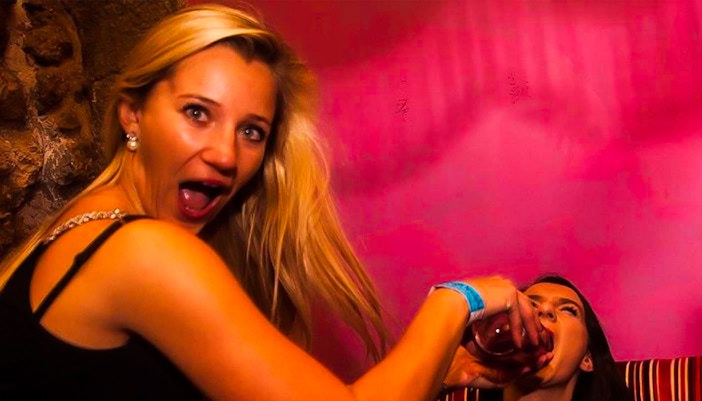 Krakow pub crawl group enjoying drinks at a lively bar in Poland.