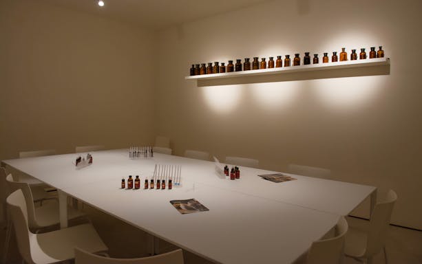 Perfume workshop setup at Mocenigo Palace-Museum with bottles and testing strips on a table.