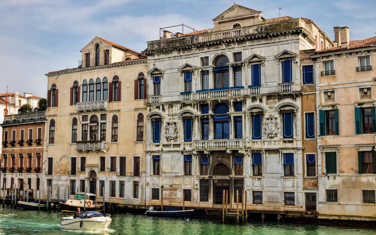 Mocenigo Palace-Museum facade along Venice canal with boats.