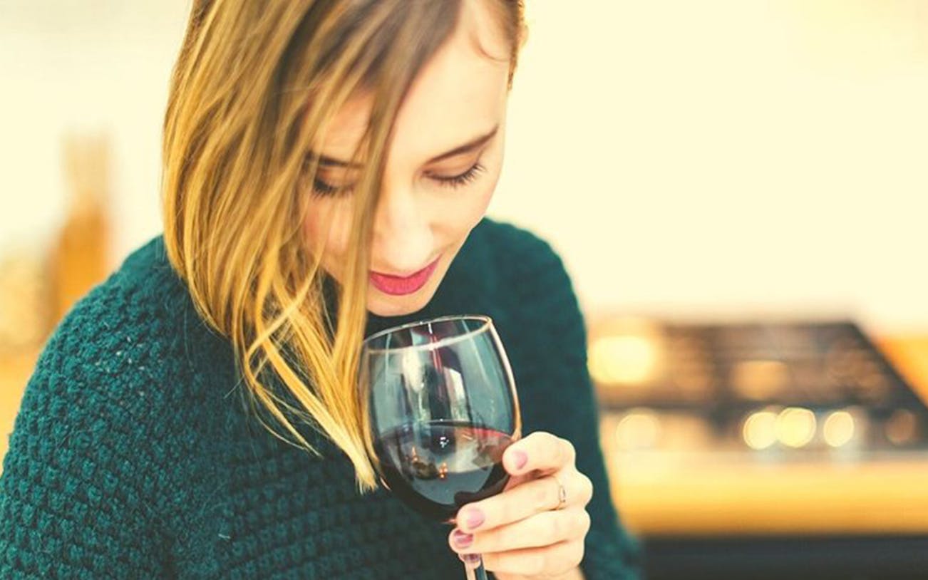 Woman enjoying wine tasting on Toledo tour from Madrid.