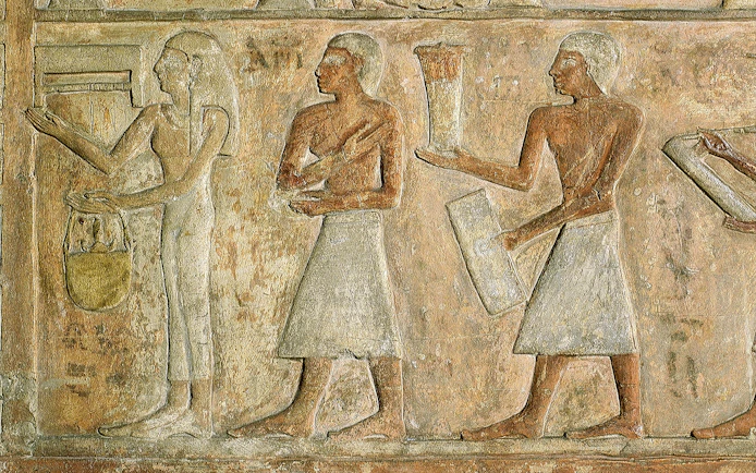 Ancient Egyptian relief depicting figures with offerings at the Egyptian Museum of Turin.