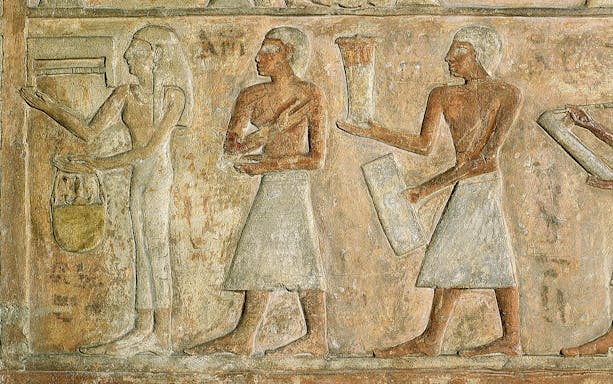 Ancient Egyptian relief depicting figures with offerings at the Egyptian Museum of Turin.