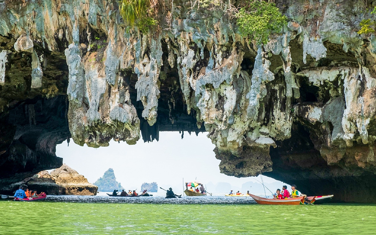Canoes exploring limestone caves at James Bond Island, Thailand.