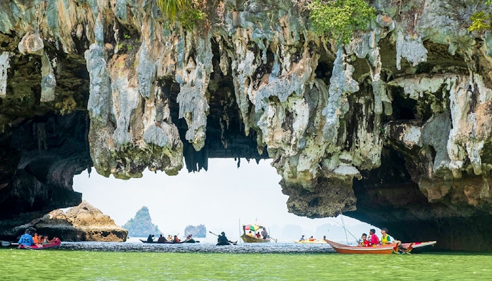 Canoes exploring limestone caves at James Bond Island, Thailand.