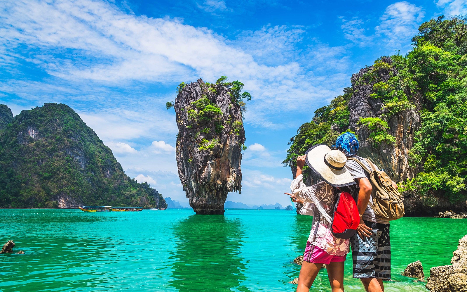 Tourists admire limestone cliffs at James Bond Island, Thailand.