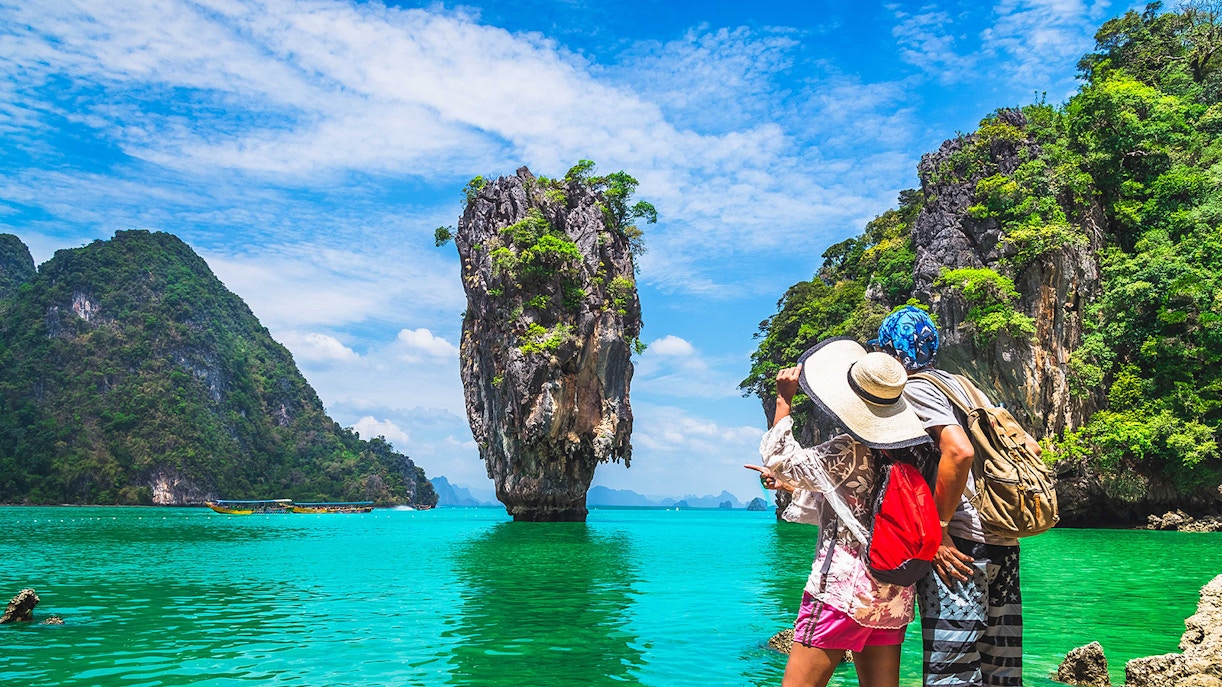 Tourists admire limestone cliffs at James Bond Island, Thailand.