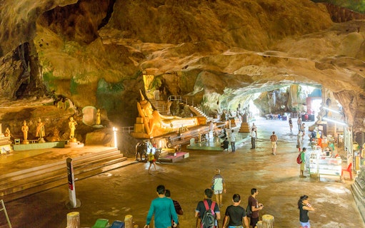 Cave temple with golden Buddha statues on James Bond Island tour.