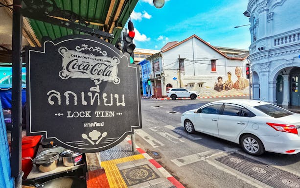 Lock Tien restaurant sign in Phuket's historic district, part of Michelin food tour.