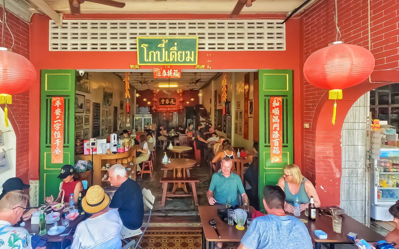 Outdoor dining at a traditional restaurant in Phuket during a Michelin food tour.