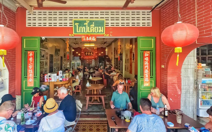 Outdoor dining at a traditional restaurant in Phuket during a Michelin food tour.
