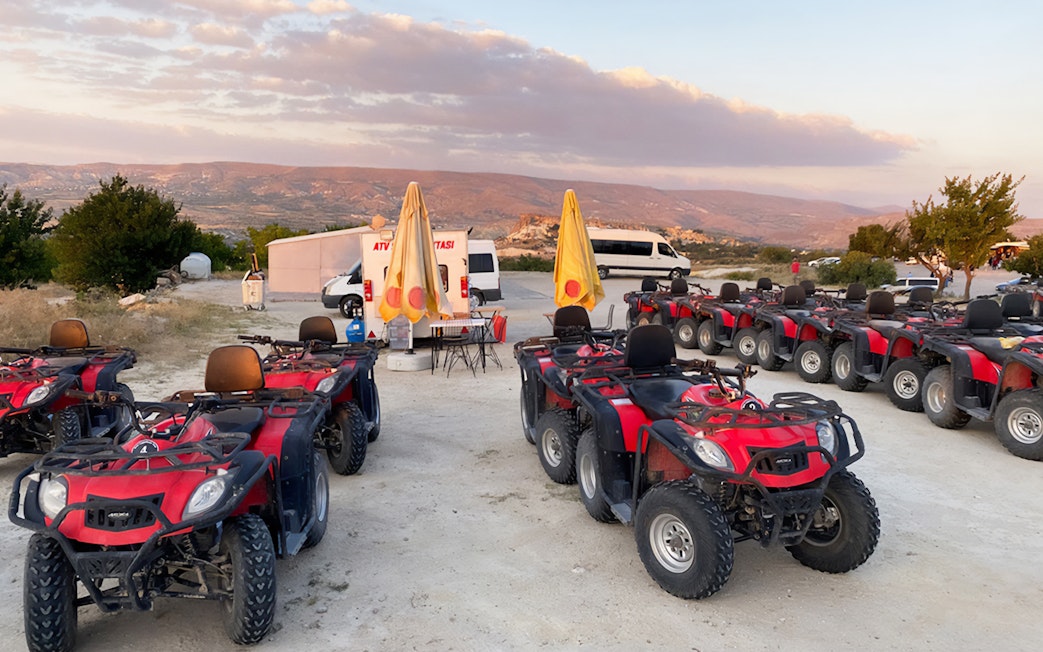 ATVs parked in Cappadocia with scenic landscape, part of the Red Tour experience.