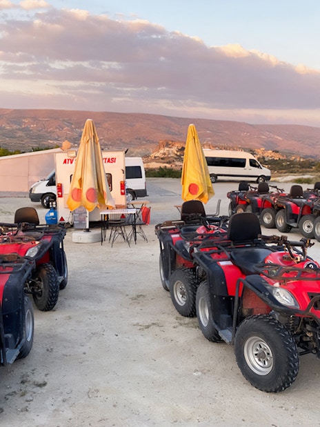 ATVs parked in Cappadocia with scenic landscape, part of the Red Tour experience.