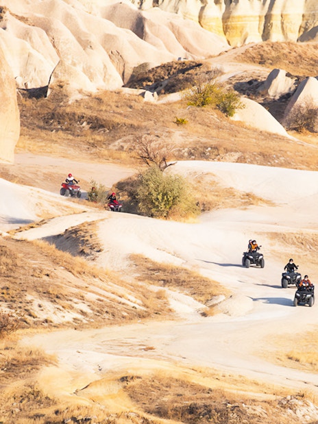 ATV riders exploring Cappadocia's unique rock formations and landscapes.