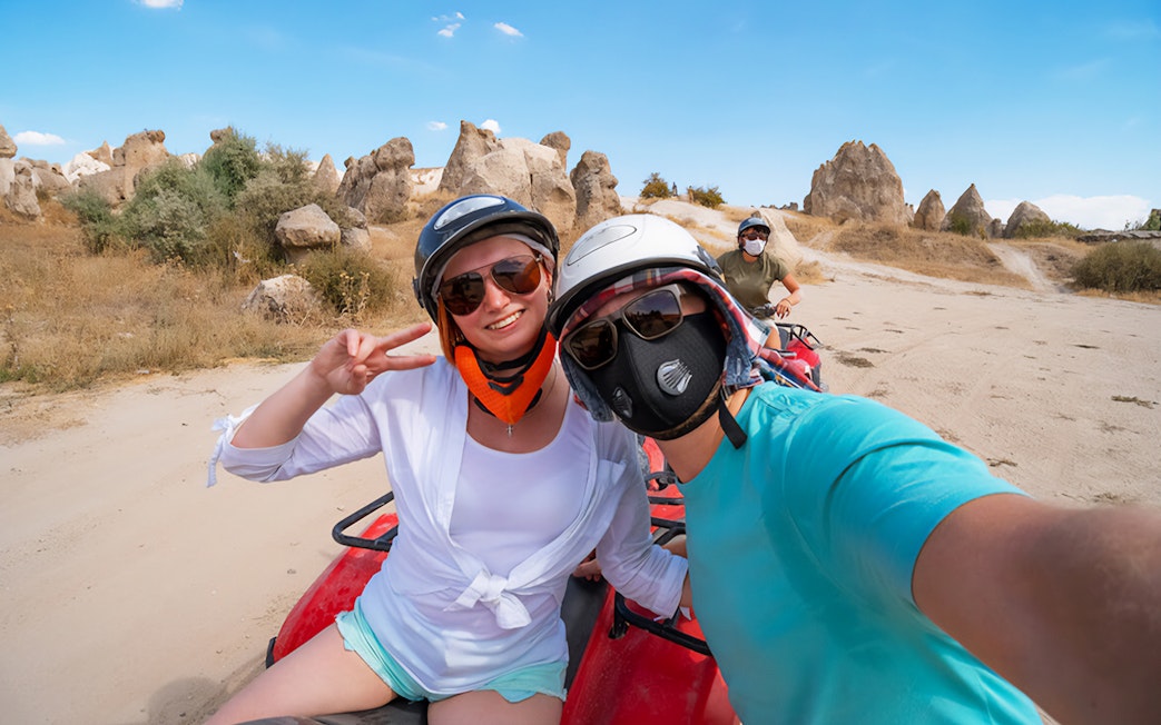 ATV riders exploring rocky landscape in Cappadocia, Turkey.