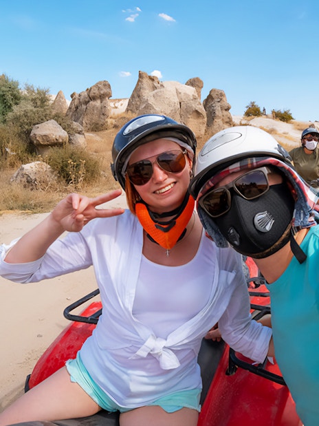 ATV riders exploring rocky landscape in Cappadocia, Turkey.