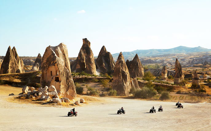 ATVs driving through Cappadocia's unique rock formations.