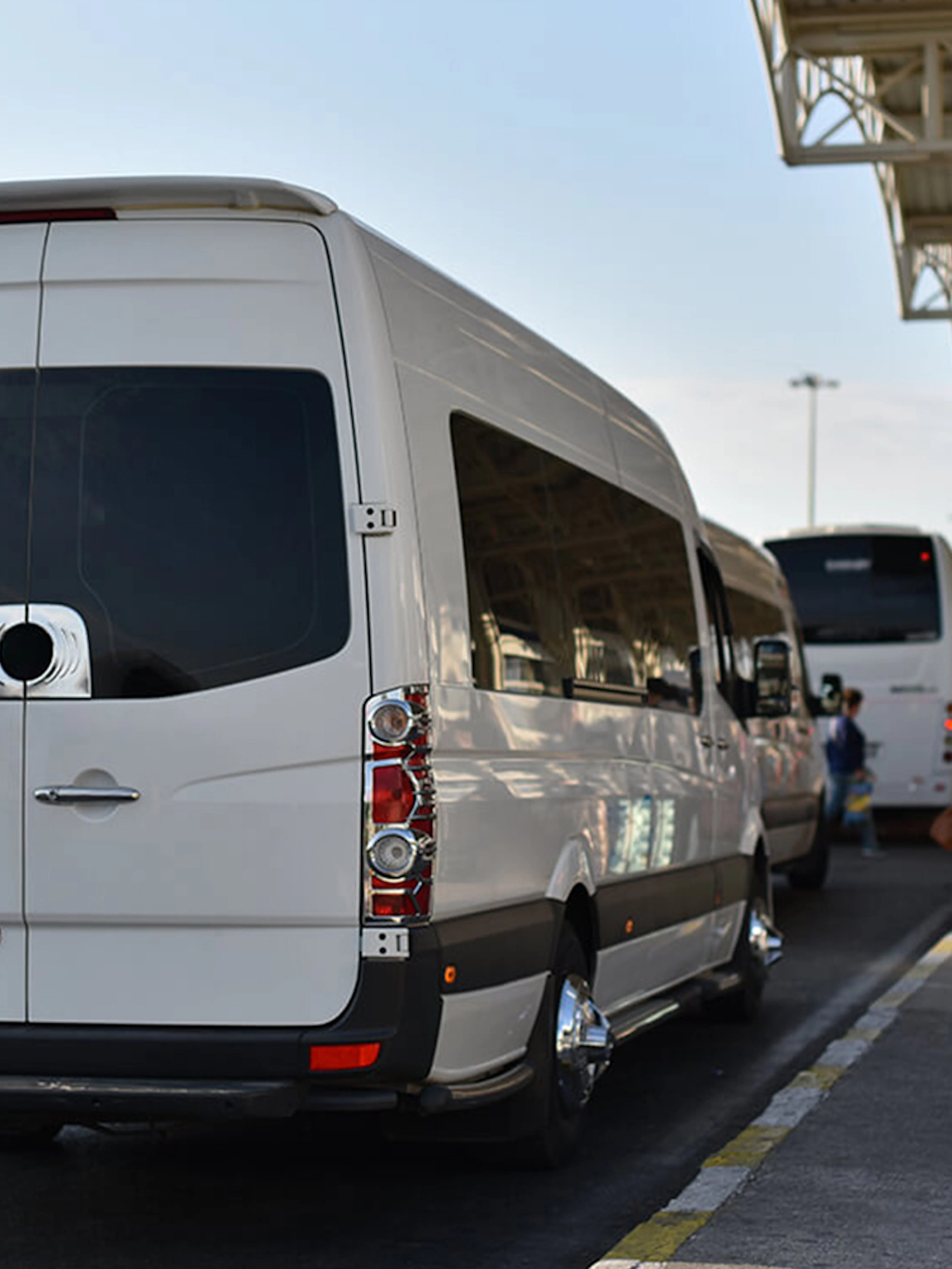 Airport shuttle van at Cappadocia terminal with passengers waiting.