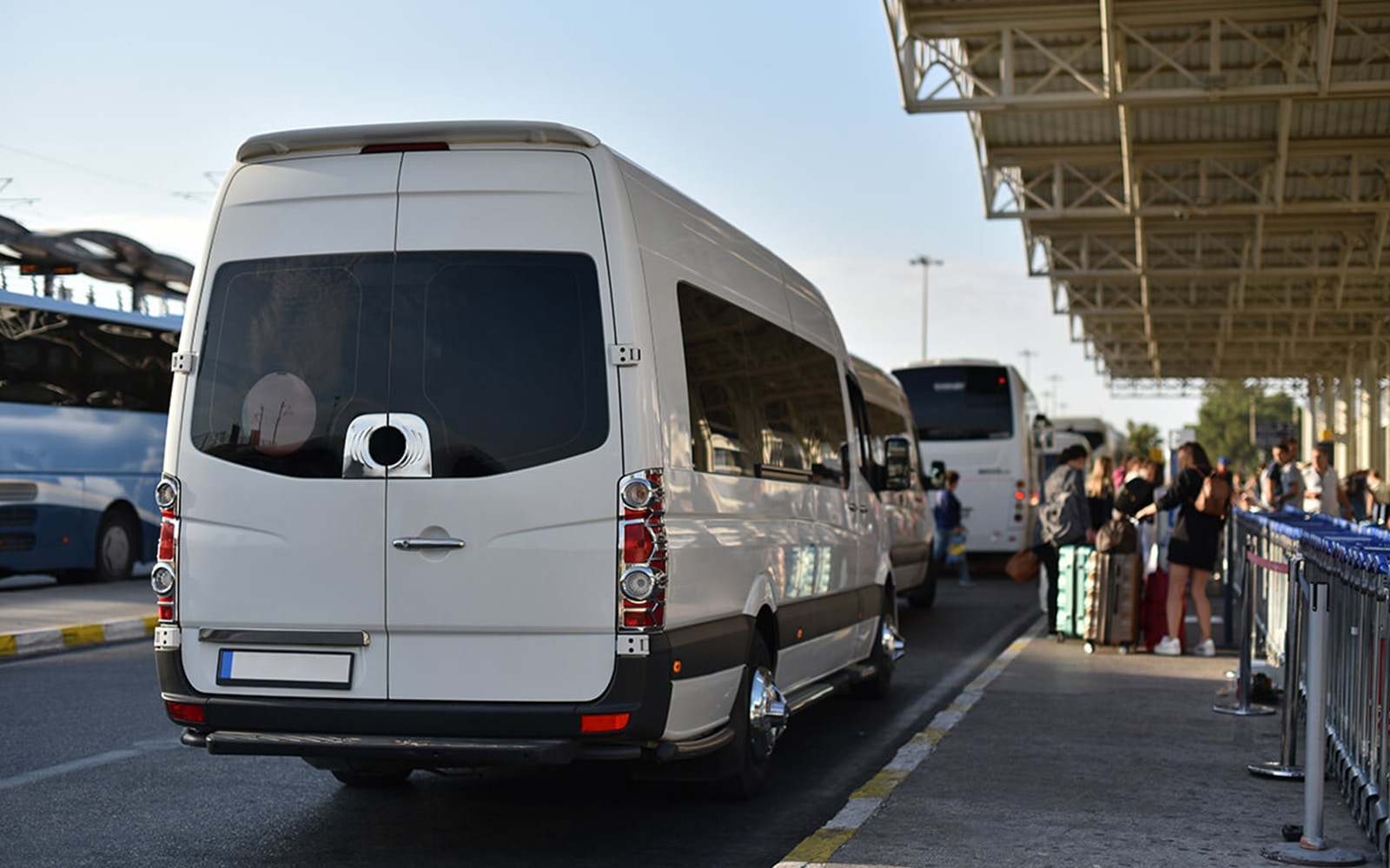 Airport shuttle van at Cappadocia terminal with passengers waiting.