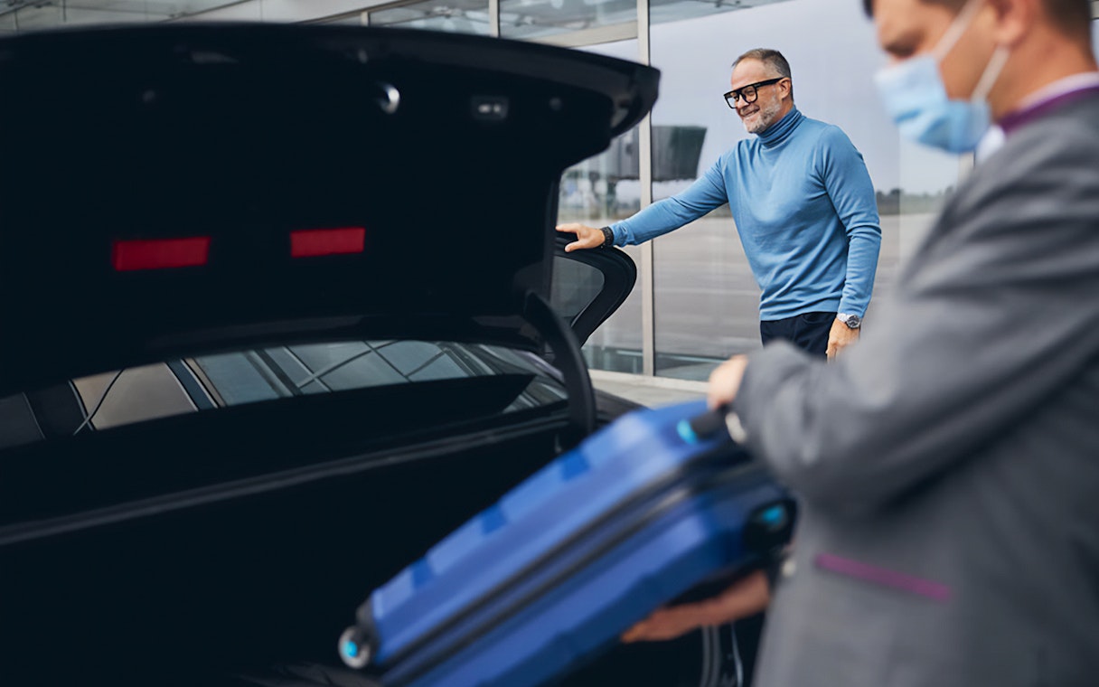 Man loading luggage into car trunk at Cappadocia airport transfer.