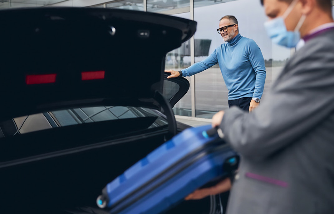 Man loading luggage in car