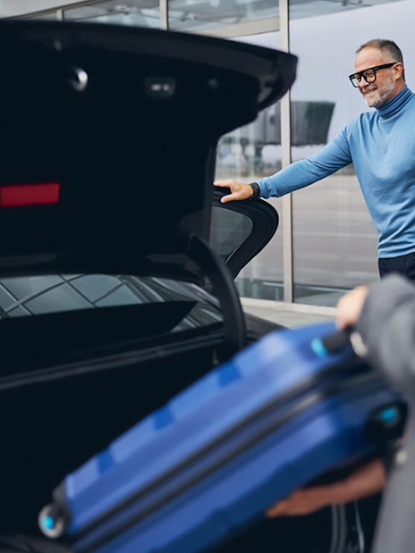 Man loading luggage into car trunk at Cappadocia airport transfer.